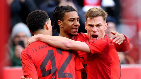 Jamal Musiala of Bayern Munich celebrates scoring his team's first goal with teammates Michael Olise and Joshua Kimmich.