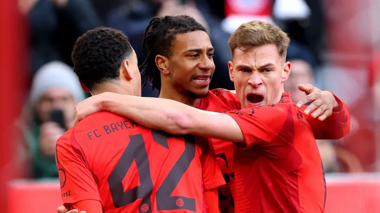 Jamal Musiala of Bayern Munich celebrates scoring his team's first goal with teammates Michael Olise and Joshua Kimmich.