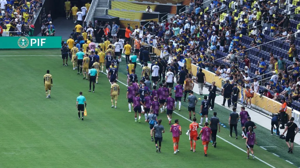 Players from Auckland City FC and CA Boca Juniors exit the pitch following a weather delay in the FIFA Club World Cup 2025 group C