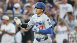 Shohei Ohtani #17 of the Los Angeles Dodgers is congratulated by Dino Ebel #91 as he circles the bases after hitting a 2 RBI home run against the Colorado Rockies in the sixth inning at Coors Field on June 24, 2025 in Denver, Colorado.