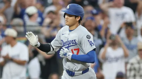 Shohei Ohtani #17 of the Los Angeles Dodgers is congratulated by Dino Ebel #91 as he circles the bases after hitting a 2 RBI home run against the Colorado Rockies in the sixth inning at Coors Field on June 24, 2025 in Denver, Colorado.