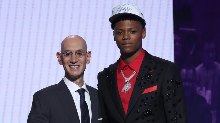 Ace Bailey (R) shakes hands with NBA commissioner Adam Silver (L) after being drafted fifth overall by the Utah Jazz during the first round of the 2025 NBA Draft at Barclays Center on June 25, 2025.