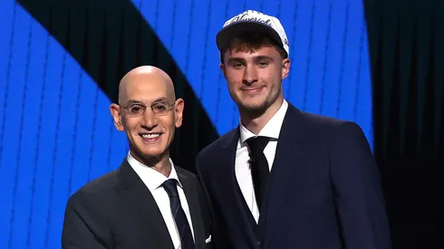 Cooper Flagg (R) shakes hands with NBA commissioner Adam Silver (L) after being drafted first overall by the Dallas Mavericks during the first round of the 2025 NBA Draft.