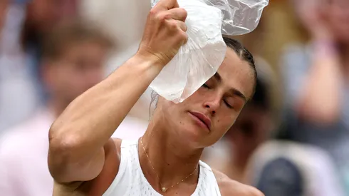 Aryna Sabalenka places an ice pack on her head during a break between sets at Wimbledon 2023