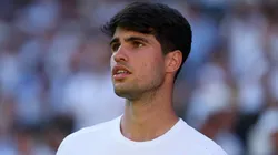 Carlos Alcaraz of Spain looks on against Fabio Fognini of Italy during the Gentlemen's Singles first round match on day one of The Championships Wimbledon 2025 at All England Lawn Tennis and Croquet Club on June 30, 2025 in London, England.