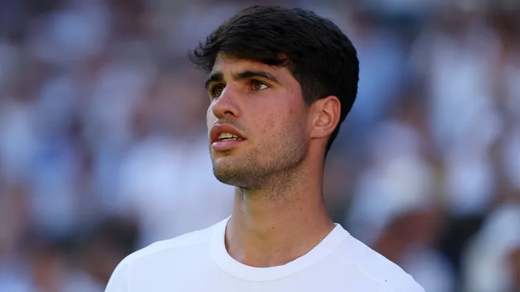 Carlos Alcaraz of Spain looks on against Fabio Fognini of Italy during the Gentlemen's Singles first round match on day one of The Championships Wimbledon 2025 at All England Lawn Tennis and Croquet Club on June 30, 2025 in London, England.