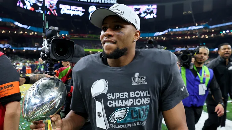 Saquon Barkley #26 of the Philadelphia Eagles celebrates with the Vince Lombardi Trophy after beating the Kansas City Chiefs 40-22 to win Super Bowl LIX at Caesars Superdome on February 09, 2025 in New Orleans, Louisiana.