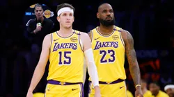 General Manager Rob Pelinka in a corner, and Austin Reaves #15 and LeBron James #23 of the Los Angeles Lakers.