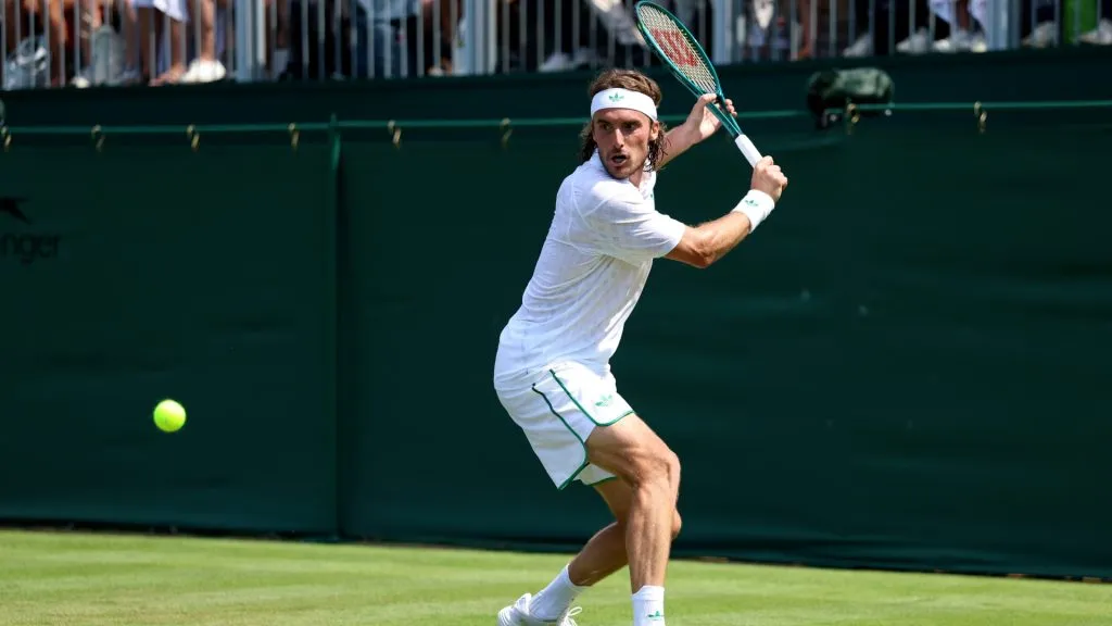 Stefanos Tsitsipas of Greece plays a backhand against Valentin Royer of France during the Gentlemen’s Singles first round match on day one of The Championships Wimbledon 2025. (Source: Dan Istitene/Getty Images)