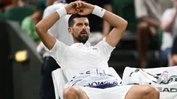 Novak Djokovic reacts from the bench during a medical timeout during the first round match against Alexandre Muller