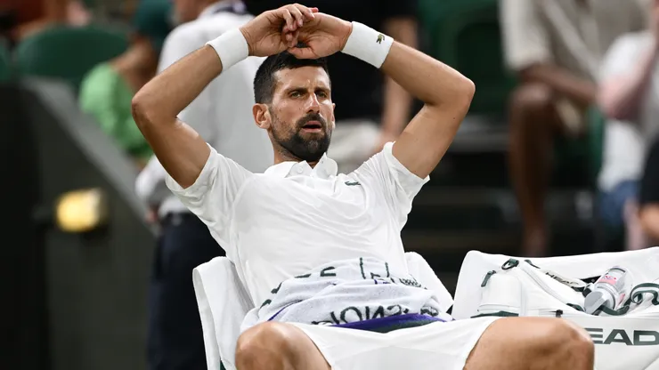 Novak Djokovic reacts from the bench during a medical timeout during the first round match against Alexandre Muller