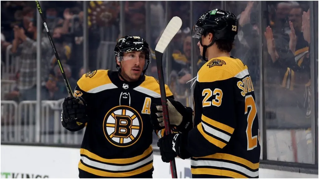 Brad Marchand #63 of the Boston Bruins celebrates with Jack Studnicka #23 after scoring a goal against the New York Rangers during the first period of the preseason game at TD Garden on October 02, 2021 in Boston, Massachusetts.