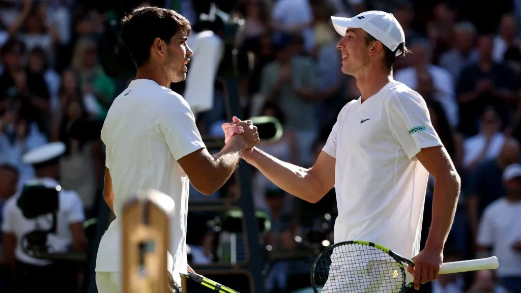 Carlos Alcaraz of Spain greets Oliver Tarvet of Great Britain