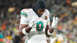 Jonnu Smith #9 of the Miami Dolphins kneels on the field prior to a game against the Green Bay Packers at Lambeau Field on November 28, 2024 in Green Bay, Wisconsin.