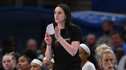Indiana Fever's Caitlin Clark cheers from the sidelines