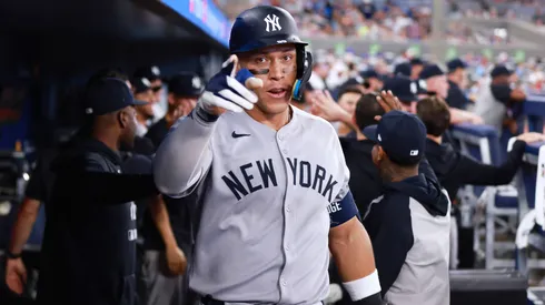 Aaron Judge #99 of the New York Yankees celebrates in the dugout after hitting a 2 run home run in the eighth inning during a game against the Toronto Blue Jays at Rogers Centre on July 02, 2025 in Toronto, Ontario, Canada.