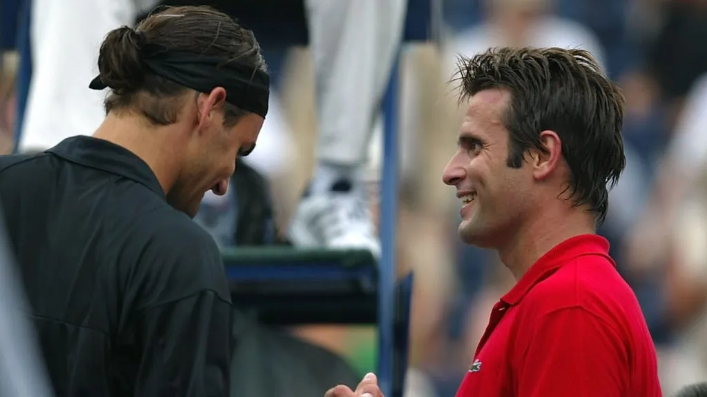 Roger Federer of Switzerland shakes hands with Fabrice Santoro of France during the Tennis Masters Canada. (Elsa/Getty Images)
