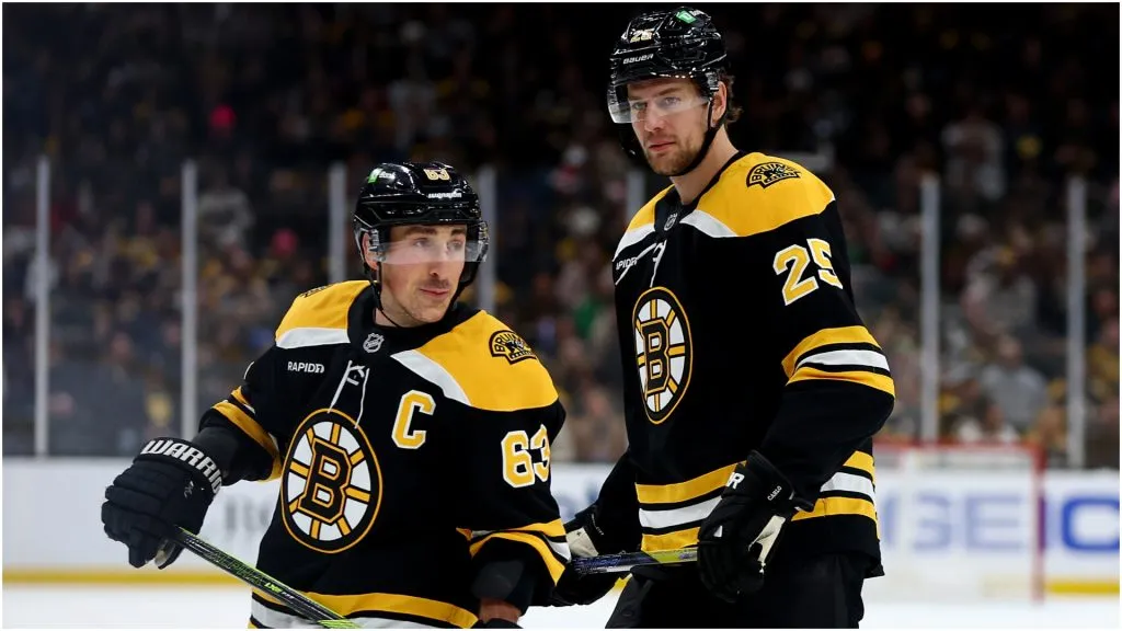 Brad Marchand #63 of the Boston Bruins and Brandon Carlo #25 look on during the first period against the Buffalo Sabres at TD Garden on December 21, 2024 in Boston, Massachusetts.