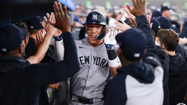 Aaron Judge #99 of the New York Yankees celebrates in the dugout after hitting a 2 run home run in the eighth inning during a game against the Toronto Blue Jays at Rogers Centre on July 02, 2025 in Toronto, Ontario, Canada.