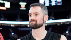 Kevin Love #42 of the Miami Heat signs an autograph for a basketball fan before the game against the Portland Trail Blazers