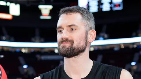 Kevin Love #42 of the Miami Heat signs an autograph for a basketball fan before the game against the Portland Trail Blazers