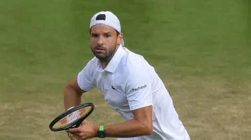 Grigor Dimitrov of Bulgaria plays a backhand against Jannik Sinner of Italy during the Gentlemen's Singles fourth round match on day eight of The Championships Wimbledon 2025 at All England Lawn Tennis and Croquet Club on July 07, 2025 in London, England.