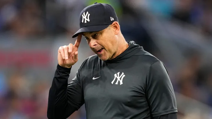 Aaron Boone of the New York Yankees walks back to the dugout after making a pitching change.