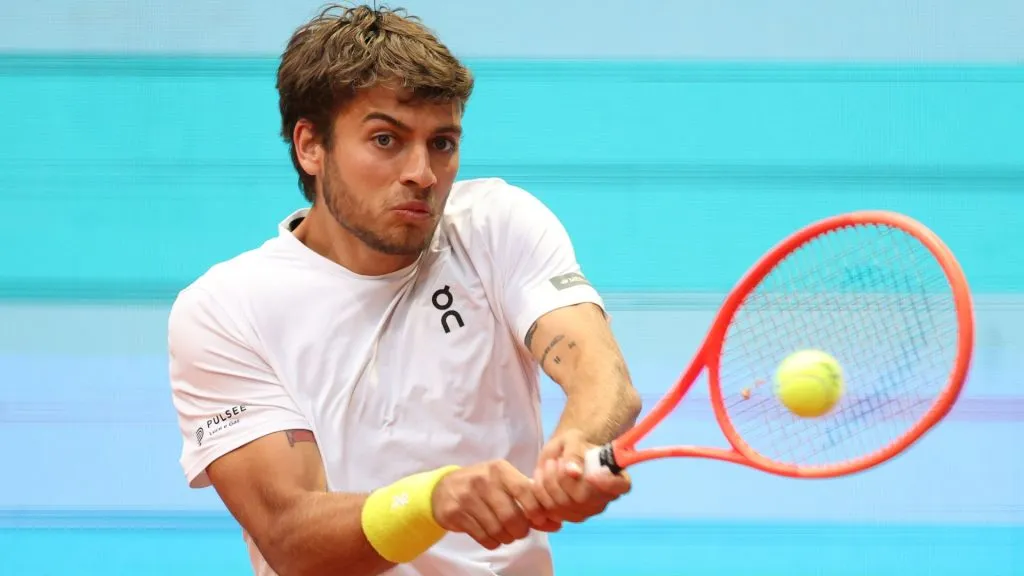 Flavio Cobolli of Italy plays a backhand during his singles match against Holger Rune of Denmark during day four of the Mutua Madrid Open at La Caja Magica on April 25, 2025. (Source: Clive Brunskill/Getty Images)