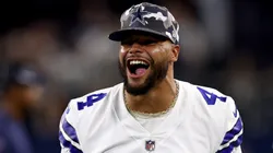 Quarterback Dak Prescott #4 of the Dallas Cowboys celebrates after safety Juanyeh Thomas #40 of the Dallas Cowboys intercepted a pass thrown by quarterback Jacob Eason #17 of the Seattle Seahawks in the fourth quarter of a NFL preseason football game at AT&T Stadium on August 26, 2022 in Arlington, Texas.