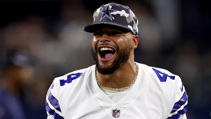 Quarterback Dak Prescott #4 of the Dallas Cowboys celebrates after safety Juanyeh Thomas #40 of the Dallas Cowboys intercepted a pass thrown by quarterback Jacob Eason #17 of the Seattle Seahawks in the fourth quarter of a NFL preseason football game at AT&T Stadium on August 26, 2022 in Arlington, Texas.