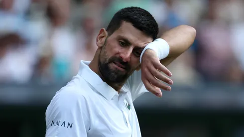 Novak Djokovic of Serbia wipes his forehead as he reacts against Flavio Cobolli of Italy during the Gentlemen's Singles quarter-final match on day ten of The Championships Wimbledon 2025
