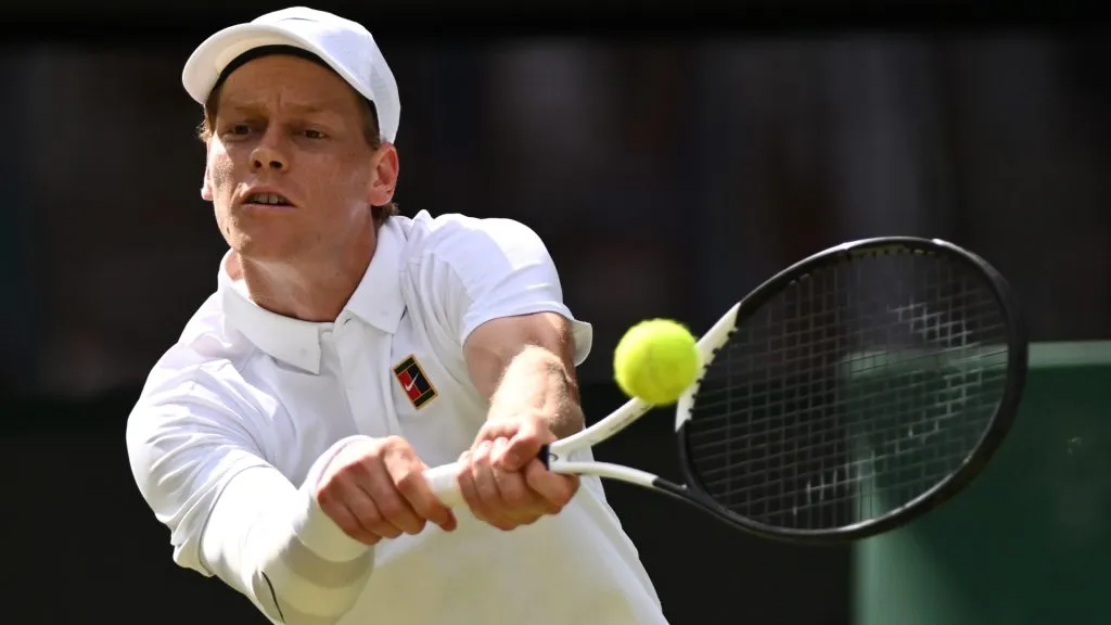 Jannik Sinner plays a backhand against Ben Shelton during the quarter-final match of Wimbledon 2025