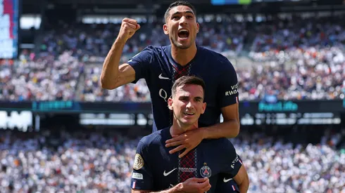 Fabian Ruiz #8 of Paris Saint-Germain celebrates scoring his team's third goal with teammate Achraf Hakimi during the FIFA Club World Cup 2025 semi-final.