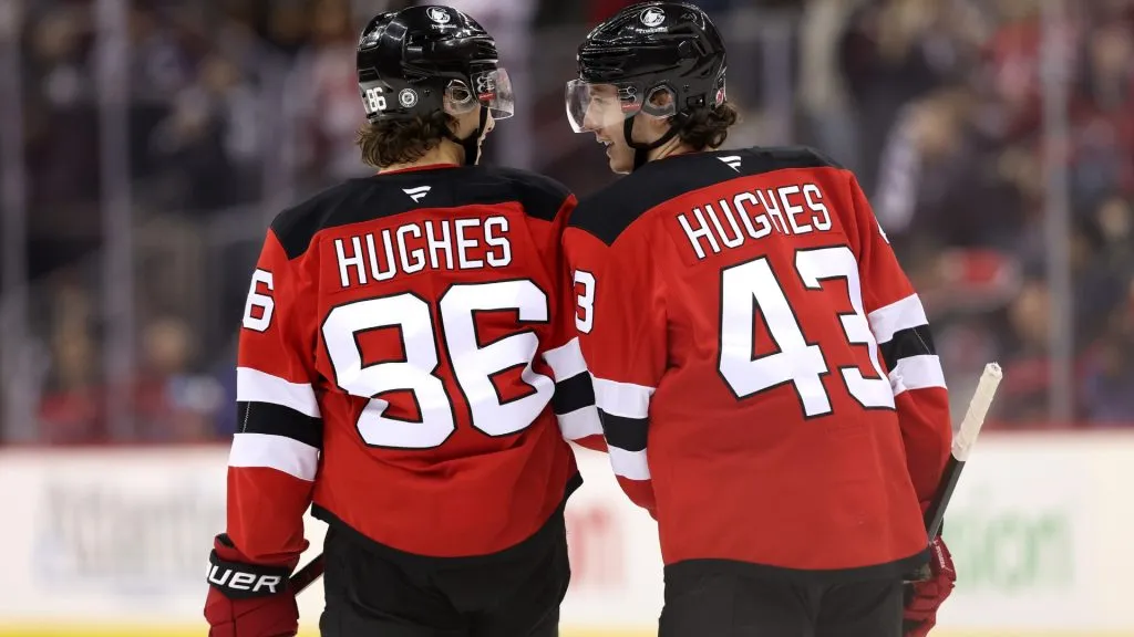 ack Hughes #86 and Luke Hughes #43 of the New Jersey Devils converse against the New York Rangers during the third period at Prudential Center on December 23, 2024 in Newark, New Jersey. (Photo by Luke Hales/Getty Images)