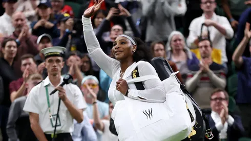 Serena Williams of The United States waves to the crowd after losing against Harmony Tan of France during their Women's Singles First Round Match on day two of The Championships Wimbledon 2022.