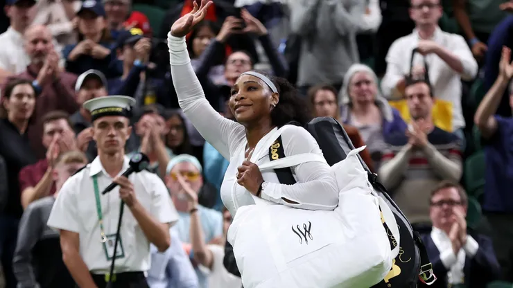 Serena Williams of The United States waves to the crowd after losing against Harmony Tan of France during their Women's Singles First Round Match on day two of The Championships Wimbledon 2022.