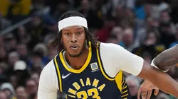 Myles Turner #33 of the Indiana Pacers dribbles the ball while being guarded by Naz Reid #11 of the Minnesota Timberwolves in the first quarter