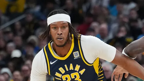 Myles Turner #33 of the Indiana Pacers dribbles the ball while being guarded by Naz Reid #11 of the Minnesota Timberwolves in the first quarter
