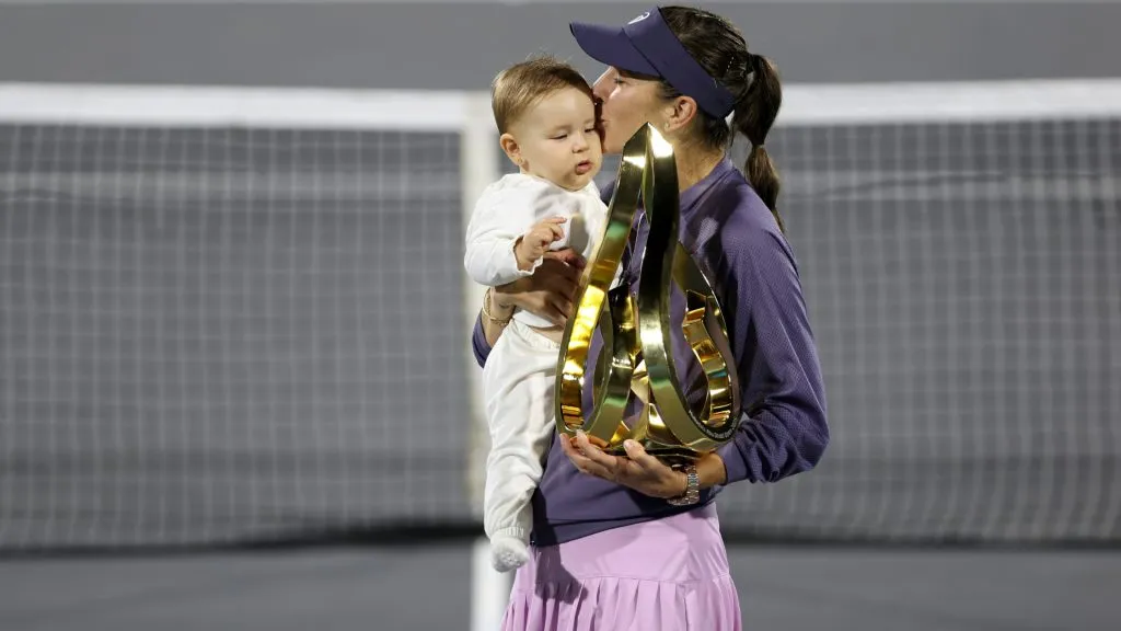 Belinda Bencic of Switzerland holds her daughter after victory against Ashlyn Krueger. (Christopher Pike/Getty Images)
