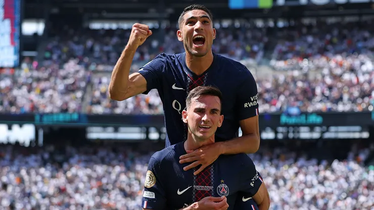 Fabian Ruiz #8 of Paris Saint-Germain celebrates scoring his team's third goal with teammate Achraf Hakimi during the FIFA Club World Cup 2025 semi-final match.