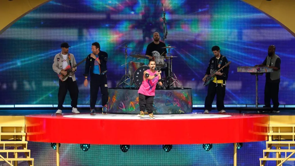 Chris Martin of Coldplay and Emmanuel Kelly perform during the halftime show during the FIFA Club World Cup 2025 Final match between Chelsea FC and Paris Saint-Germain. (Source: Michael Reaves/Getty Images)
