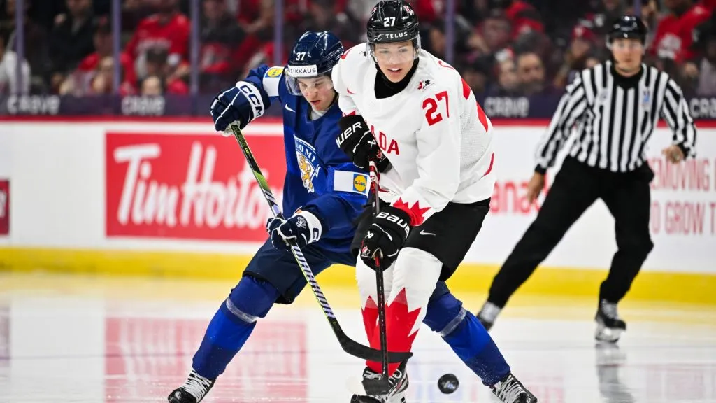 Easton Cowan #27 of Team Canada and Benjamin Rautiainen #37 of Team Finland skate after the puck during the third period at the 2025 IIHF World Junior Championship at Canadian Tire Centre December 26, 2024 in Ottawa, Ontario, Canada. Team Canada defeated Team Finland 4-0. (Photo by Minas Panagiotakis/Getty Images)