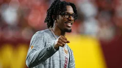 Jayden Daniels #5 of the Washington Commanders reacts in street clothes in the second quarter of a preseason game against the New England Patriots at Commanders Field on August 25, 2024 in Landover, Maryland.