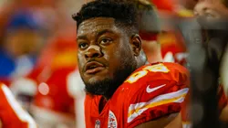 Trey Smith #65 of the Kansas City Chiefs sits on the Chiefs bench during the game against the Denver Broncos at Arrowhead Stadium on December 5, 2021.