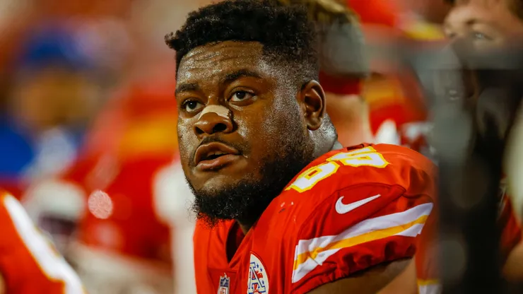 Trey Smith #65 of the Kansas City Chiefs sits on the Chiefs bench during the game against the Denver Broncos at Arrowhead Stadium on December 5, 2021.