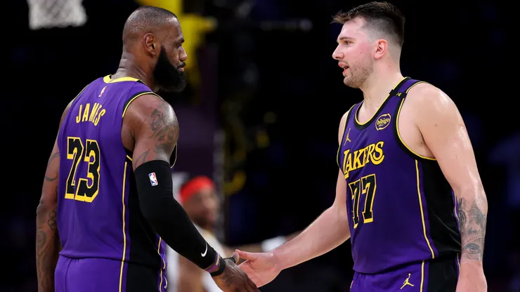 LeBron James #23 and Luka Doncic #77 of the Los Angeles Lakers shake hands against the New Orleans Pelicans during the second quarter at Crypto.com Arena on April 04, 2025 in Los Angeles, California.
