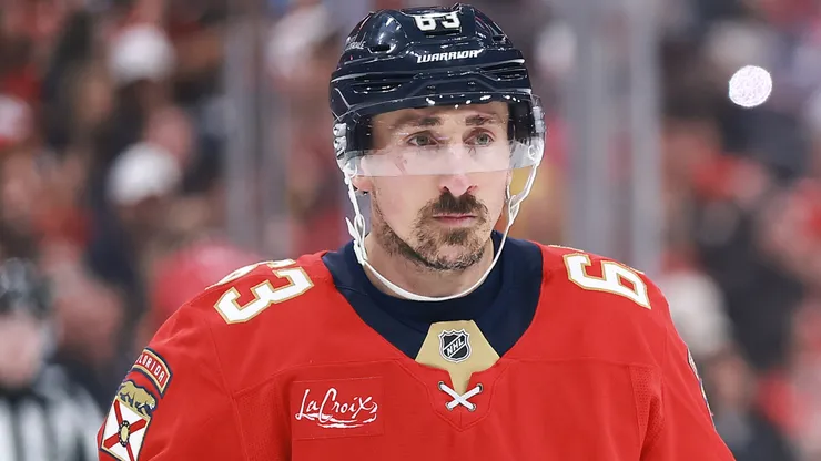 Brad Marchand skates on the ice during an NHL game, focused on the play ahead.