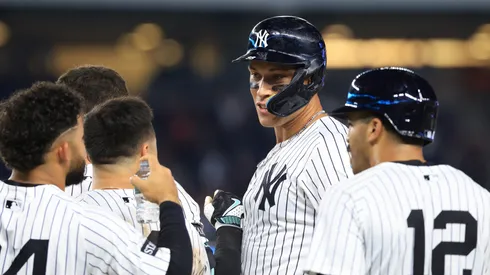 Aaron Judge #99 of the New York Yankees waits for a video replay call with teammates after hitting a walk-off sacrifice fly ball during the tenth inning against the Seattle Mariners.