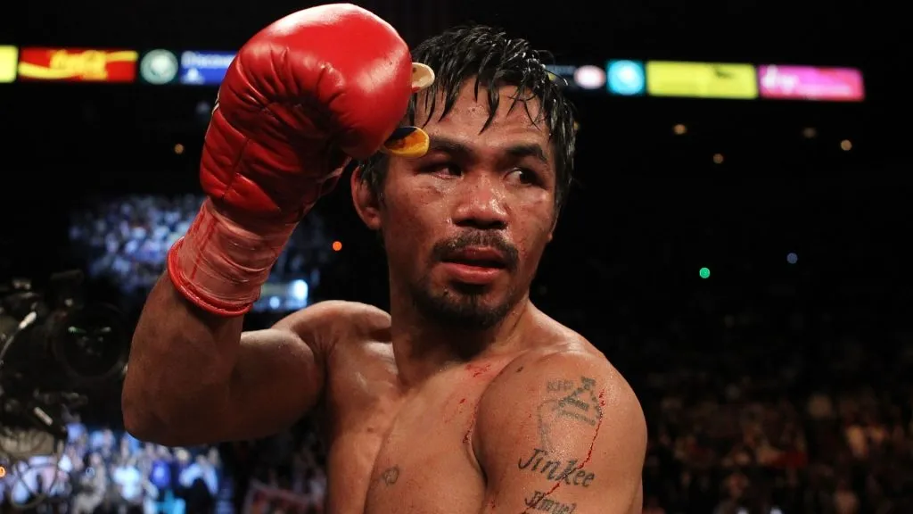Manny Pacquiao celebrates his 12 round TKO victory against Miguel Cotto during their WBO welterweight title fight at the MGM Grand Garden Arena on November 14, 2009. (Source: Al Bello/Getty Images)