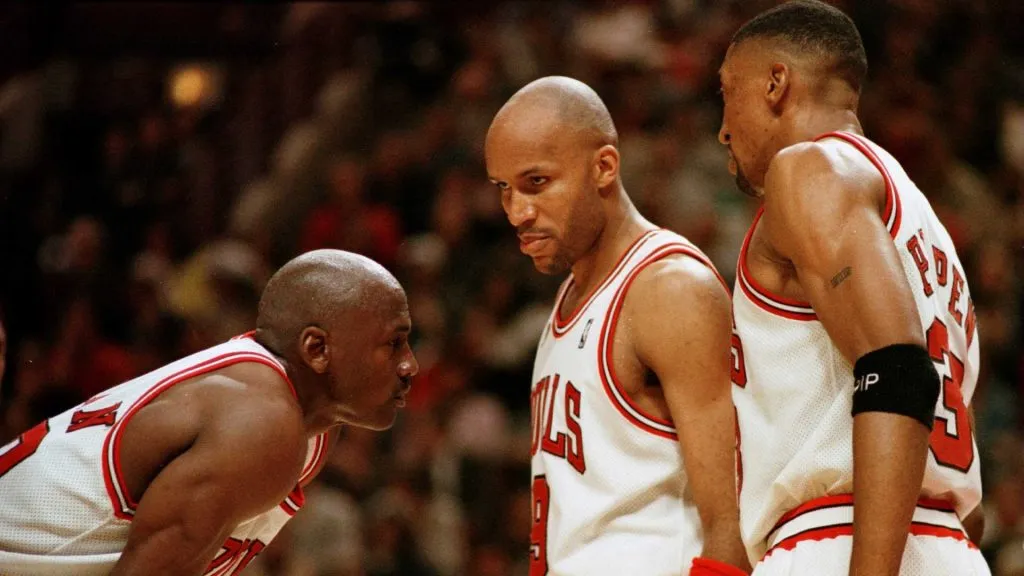 Michael Jordan discusses strategy with teammates Ron Harper and Scottie Pippen during the fourth quarter of game two in the 1996 NBA Finals at the United Center.